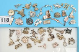 ASSORTED SILVER AND WHITE METAL CHARMS, to include a silver ingot, hallmarked Birmingham,