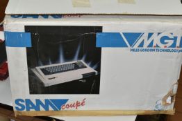 MGT SAM COUPE COMPUTER BOXED, includes some tapes and guides, tapes are untested and the box shows