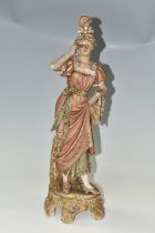 A ROYAL DUX PORCELAIN FIGURE OF A YOUNG WOMAN WITH SPECTACLES/LORGNETTES, applied pink Royal Dux