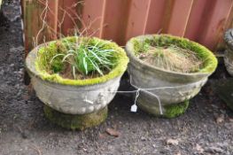 A PAIR OF WEATHERED COMPOSITE CIRCULAR GARDEN PLANTERS with foliate detail and fluted bowl 46cm in