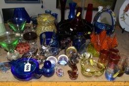 A GROUP OF COLOURED GLASSWARE, including assorted modern paperweights, a handkerchief vase, ashtrays