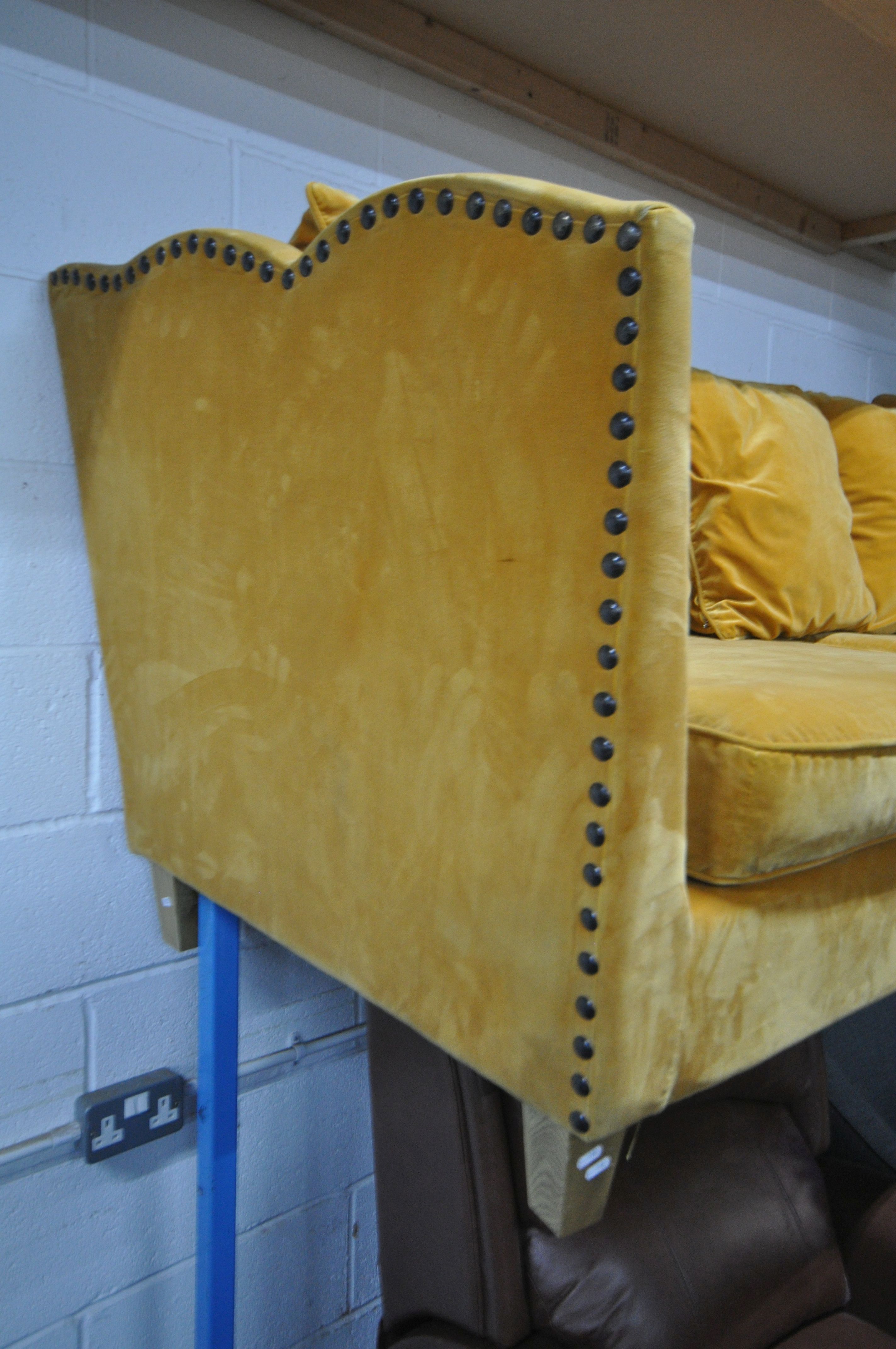 A GOLD VELOUR UPHOLSTERED SOFA, with a studded back, sides, and a shaped top, on square light oak - Image 4 of 8