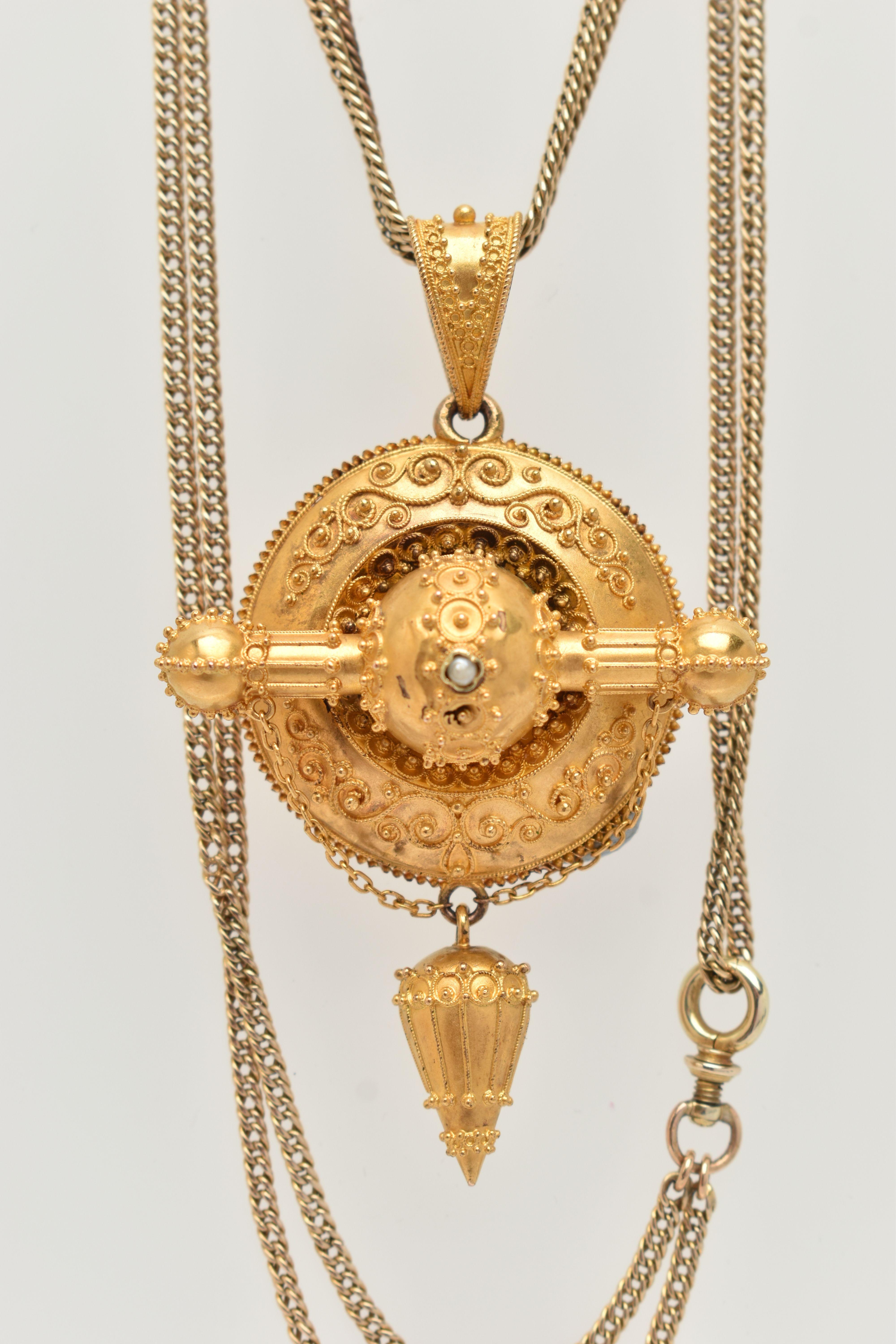 A LATE GEORGIAN/EARLY VICTORIAN PENDANT, of circular outline with cannetille detail, central seed