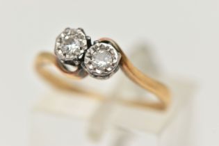 AN 18CT GOLD DIAMOND TWO STONE RING, cross over ring, set with two round brilliant cut diamonds,