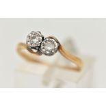 AN 18CT GOLD DIAMOND TWO STONE RING, cross over ring, set with two round brilliant cut diamonds,