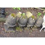 A COLLECTION OF FIVE ACORN SHAPED GATE POST FINIALS with tapered square feet (four cemented together