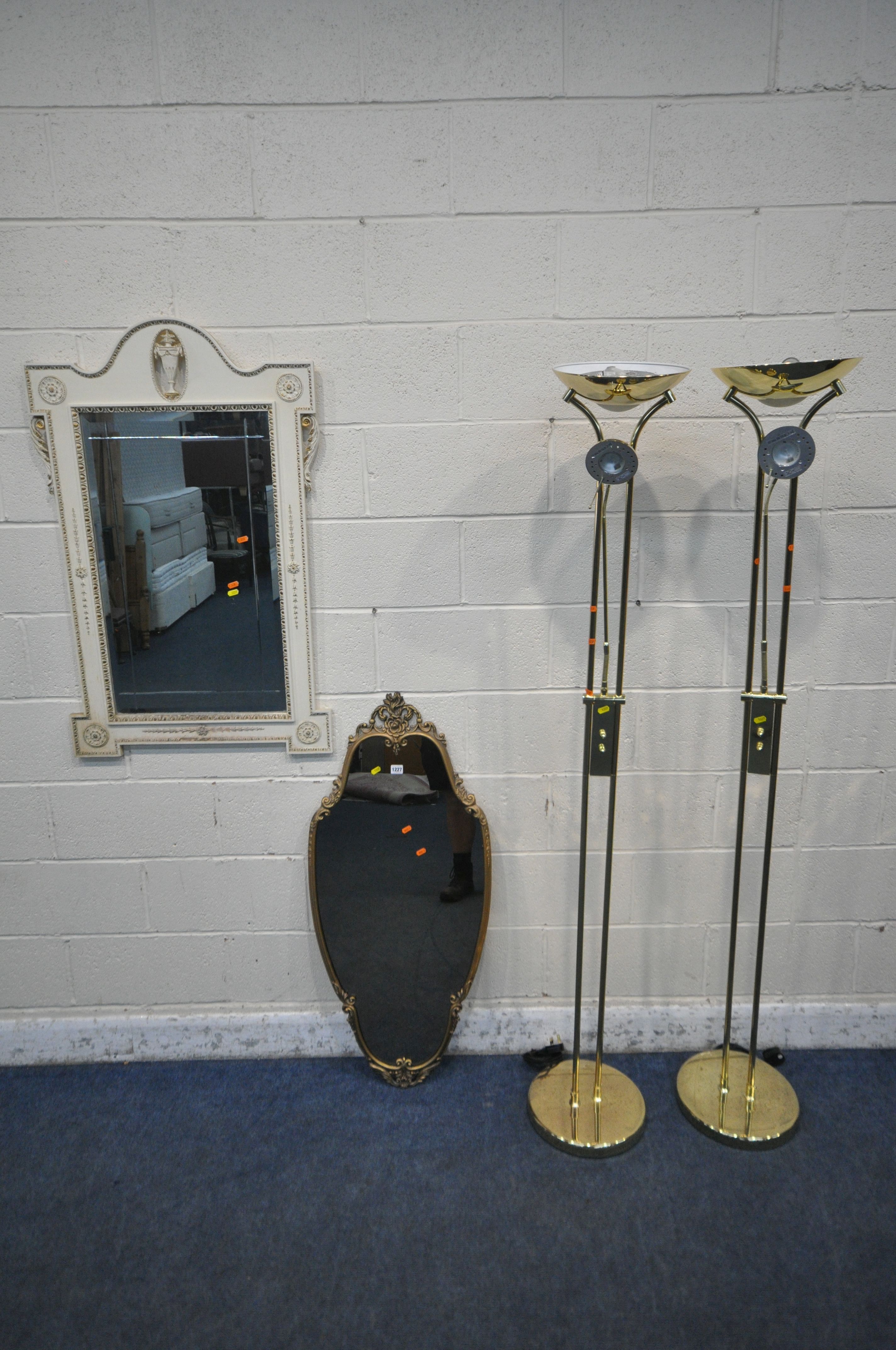 A GILT METAL FRAMED WALL MIRROR, with scrolled and foliate details, 50cm x 110cm, a French wall