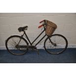 A VINTAGE RALEIGH LADIES BIKE (IDEAL FOR RESTORATION) with basket to front and a distressed