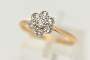 A YELLOW AND WHITE METAL DIAMOND FLOWER RING, white metal flower head set with seven small single