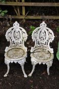 A PAIR OF VICTORIAN CAST IRON PAINTED GARDEN CHAIRS with pierced detail to seat and back and