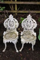 A PAIR OF VICTORIAN CAST IRON PAINTED GARDEN CHAIRS with pierced detail to seat and back and