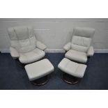 TWO SIZED EKORNES STRESSLESS CREAM LEATHER ARMCHAIRS, along with a pair of footstools (condition