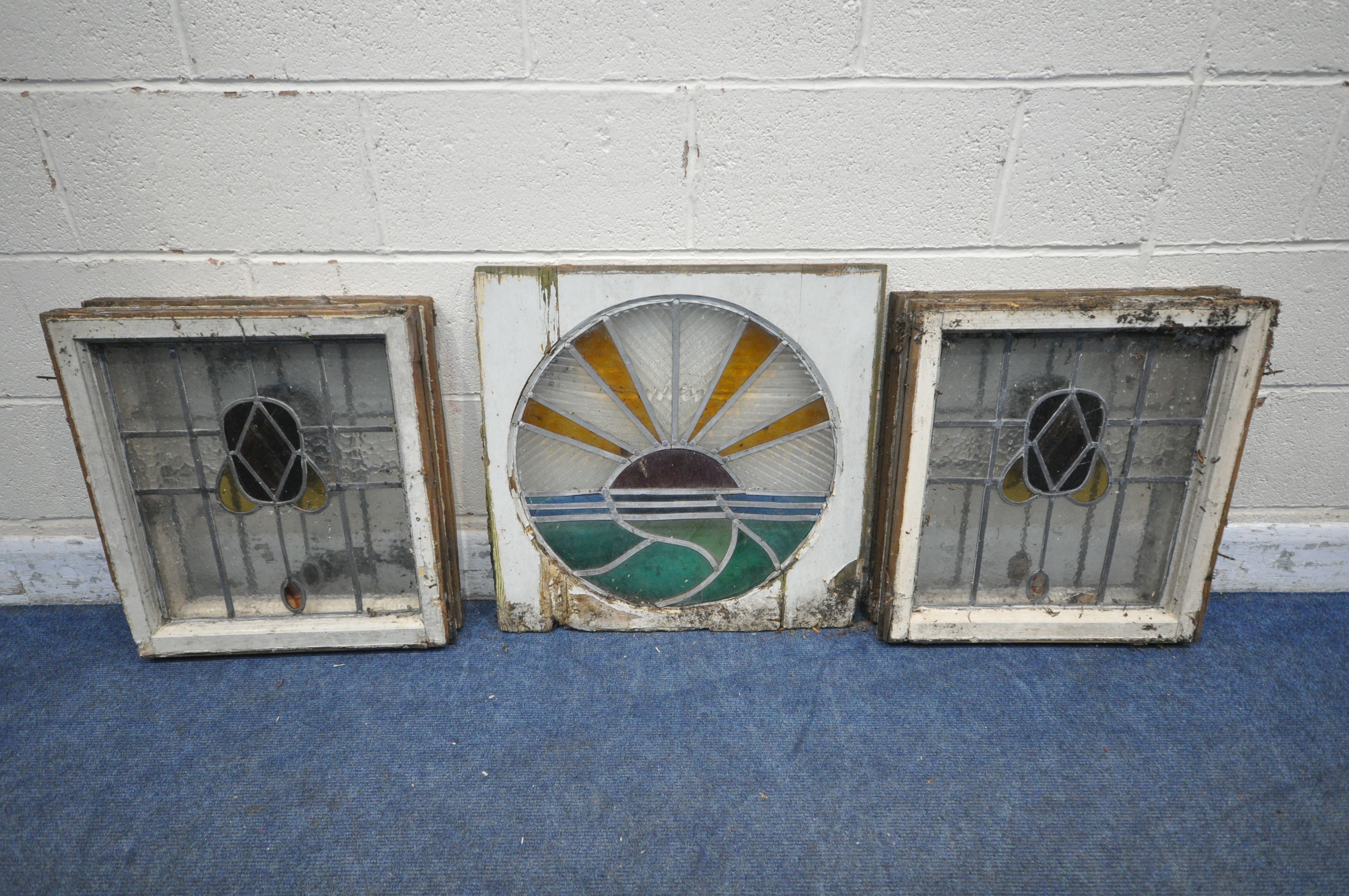 FOUR MATCHING LEAD GLAZED STAINED GLASS WINDOWS, frame size 50cm x 55cm, along with a circular