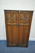 A 20TH CENTURY OAK GENTLEMAN'S WARDROBE, the double doors enclosing a fitted interior, width 94cm