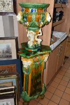 A MODERN MAJOLICA JARDINIERE ON STAND, the jardiniere modelled with lion head masks holding garlands