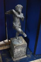 A SECOND HALF 20TH CENTURY WEATHERED BRONZE FIGURE OF CHERUB POSED HOLDING PAN PIPES, on a