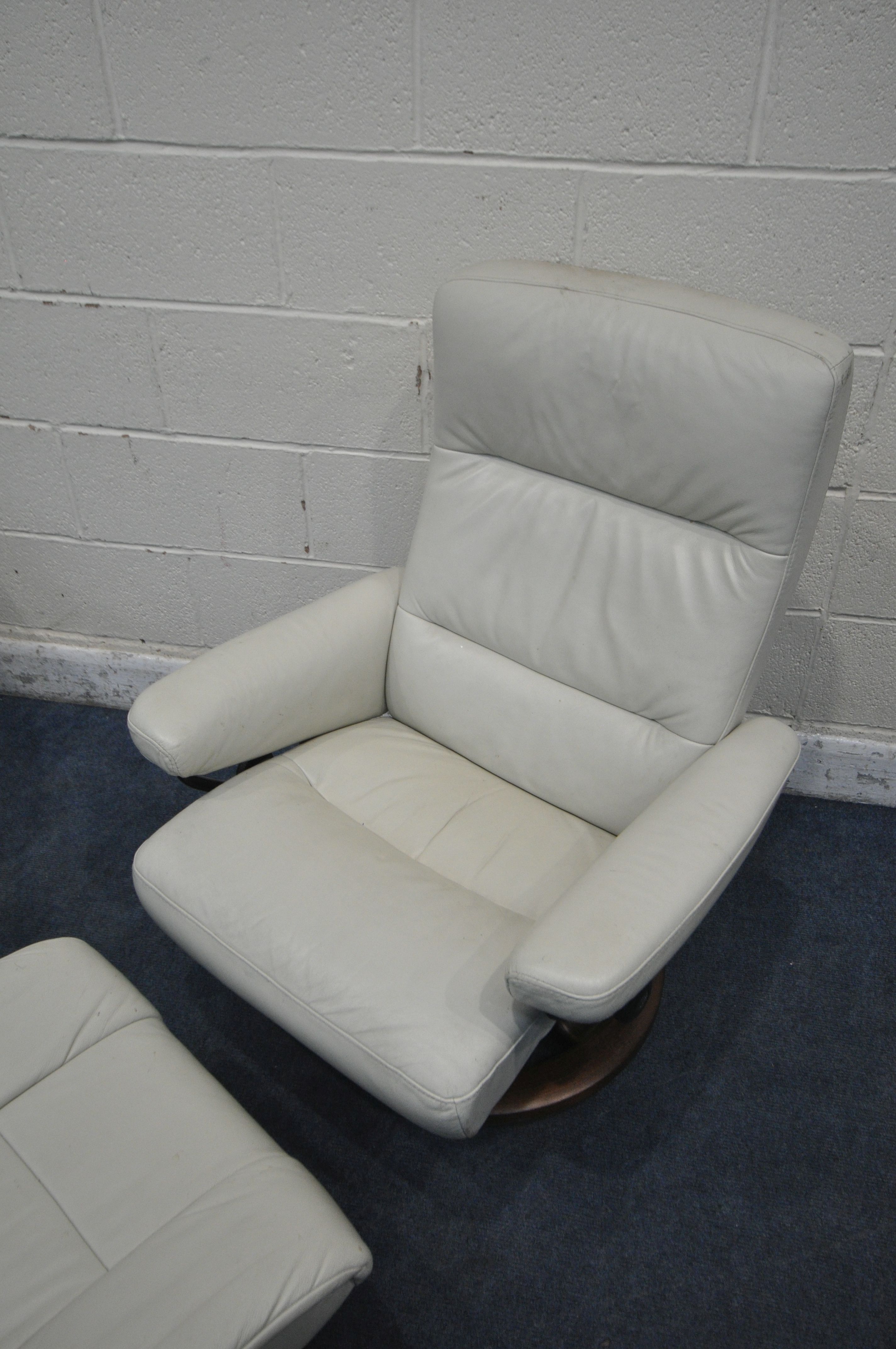 TWO SIZED EKORNES STRESSLESS CREAM LEATHER ARMCHAIRS, along with a pair of footstools (condition - Image 3 of 6