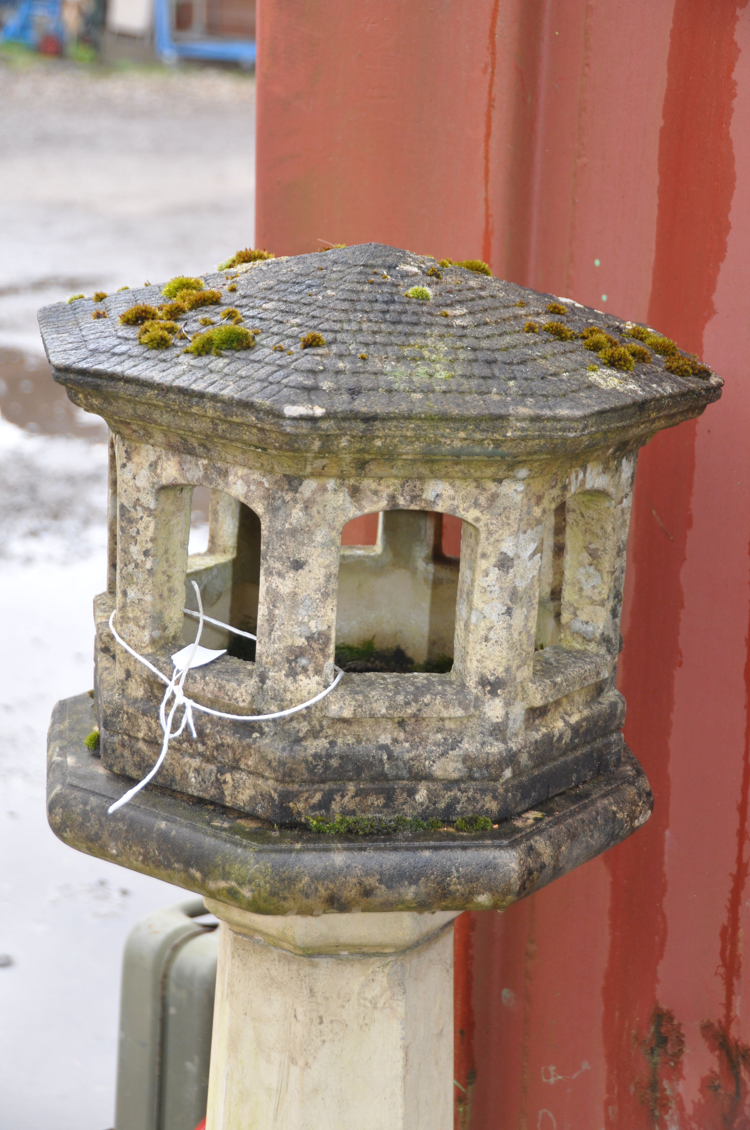 A WEATHERED COMPOSITE ORIENTAL STYLE BIRD HOUSE with octagonal tapering column beneath an - Image 2 of 2