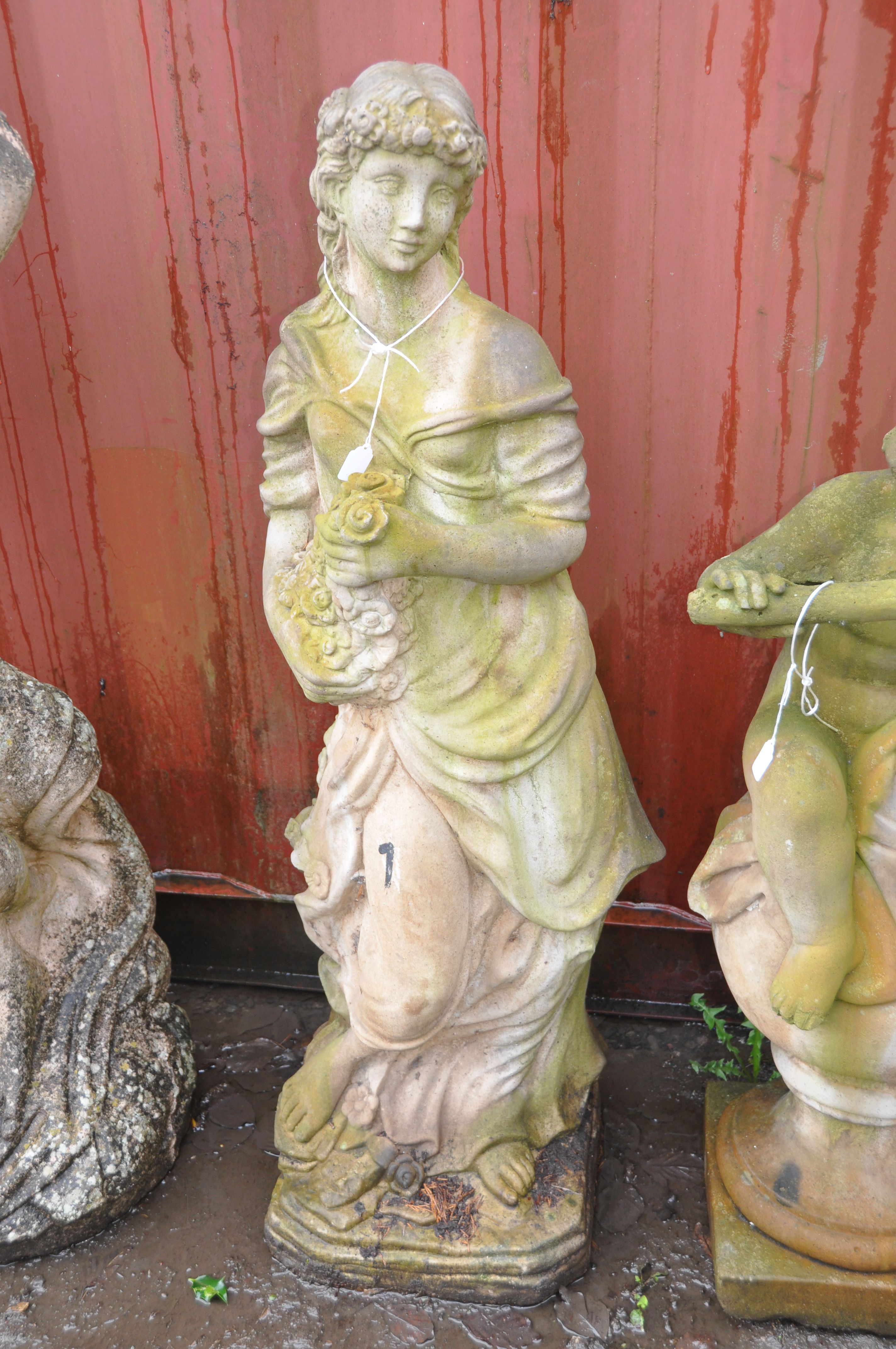 A WEATHERED COMPOSITE FIGURE OF A LADY CARRYING FLOWERS standing height 120cm (Condition Report: