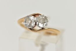 A YELLOW METAL DIAMOND TWO STONE RING, two old cut diamonds, each in a ten claw white metal setting,