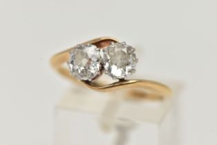 A YELLOW METAL DIAMOND TWO STONE RING, two old cut diamonds, each in a ten claw white metal setting,