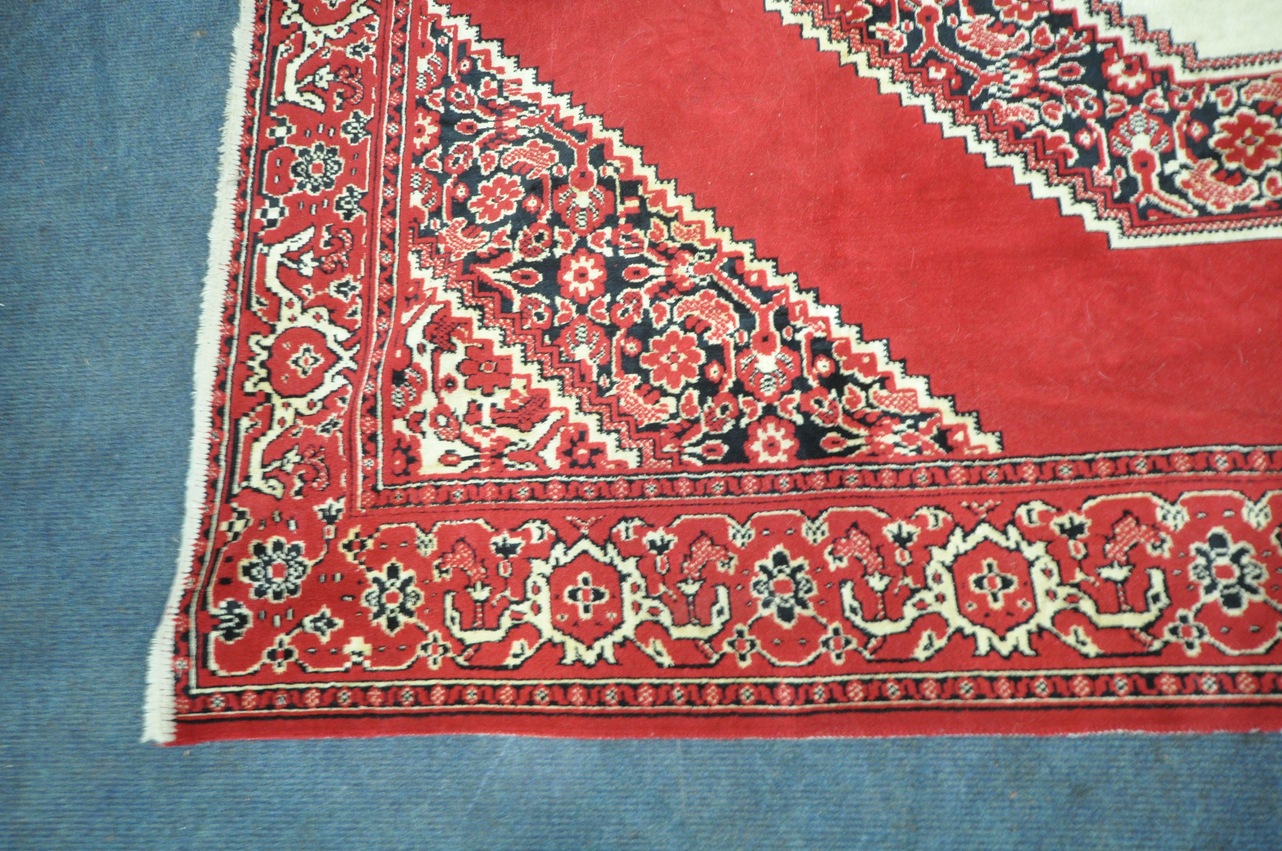 A RED GROUND SYNTHETIC SILK RUG, with central medallion, foliate designs and multi-strap border, - Image 2 of 5