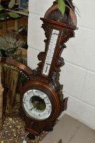 AN OAK BAROMETER AND A COPPER FRAMED MIRROR, comprising a carved banjo barometer with thermometer on