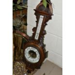 AN OAK BAROMETER AND A COPPER FRAMED MIRROR, comprising a carved banjo barometer with thermometer on