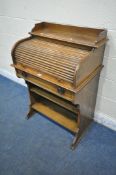 A 20TH CENTURY OAK BUREAU, with a raised back, a rolling tambour door enclosing a fitted interior,