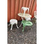 A WEATHERED PAINTED ALUMINIUM GARDEN TABLE with pierced detail 80cm in diameter, three similar