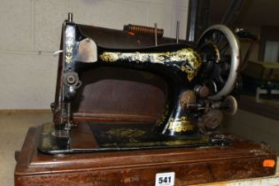 A CASED SINGER SEWING MACHINE, Serial No.12356743, in well used condition with paint loss and wear