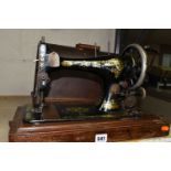 A CASED SINGER SEWING MACHINE, Serial No.12356743, in well used condition with paint loss and wear