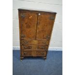 A 20TH CENTURY WALNUT TALLBOY, fitted with double doors, above three drawers, raised on cabriole