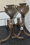A PAIR OF ARTS AND CRAFTS PLANISHED COPPER AND WROUGHT IRON FIRE DOGS, with scrolled spade shaped