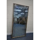 A LARGE RECTANGULAR MIRROR, with a variety of bevelled panes and a wooden frame, 190cm x 92cm (