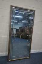 A LARGE RECTANGULAR MIRROR, with a variety of bevelled panes and a wooden frame, 190cm x 92cm (