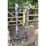 A PAIR OF PAINTED CAST IRON POSTS with what appears to be Celtic detailing, horses heads loose at
