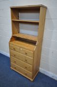 A MODERN PINE BOOKCASE / CHEST OF TWO SHORT OVER THREE LONG DRAWERS, the top section folds down