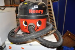 A NUMATIC HVP200 HENRY VACUUM CLEANER with pipework and floor head and a Tesco Vacuum cleaner (