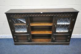 A 20TH CENTURY OAK BOOKCASE, with two lead glazed doors, two cupboard doors and an arrangement of