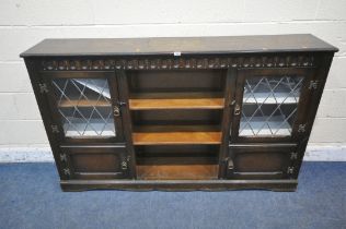 A 20TH CENTURY OAK BOOKCASE, with two lead glazed doors, two cupboard doors and an arrangement of