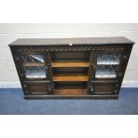 A 20TH CENTURY OAK BOOKCASE, with two lead glazed doors, two cupboard doors and an arrangement of