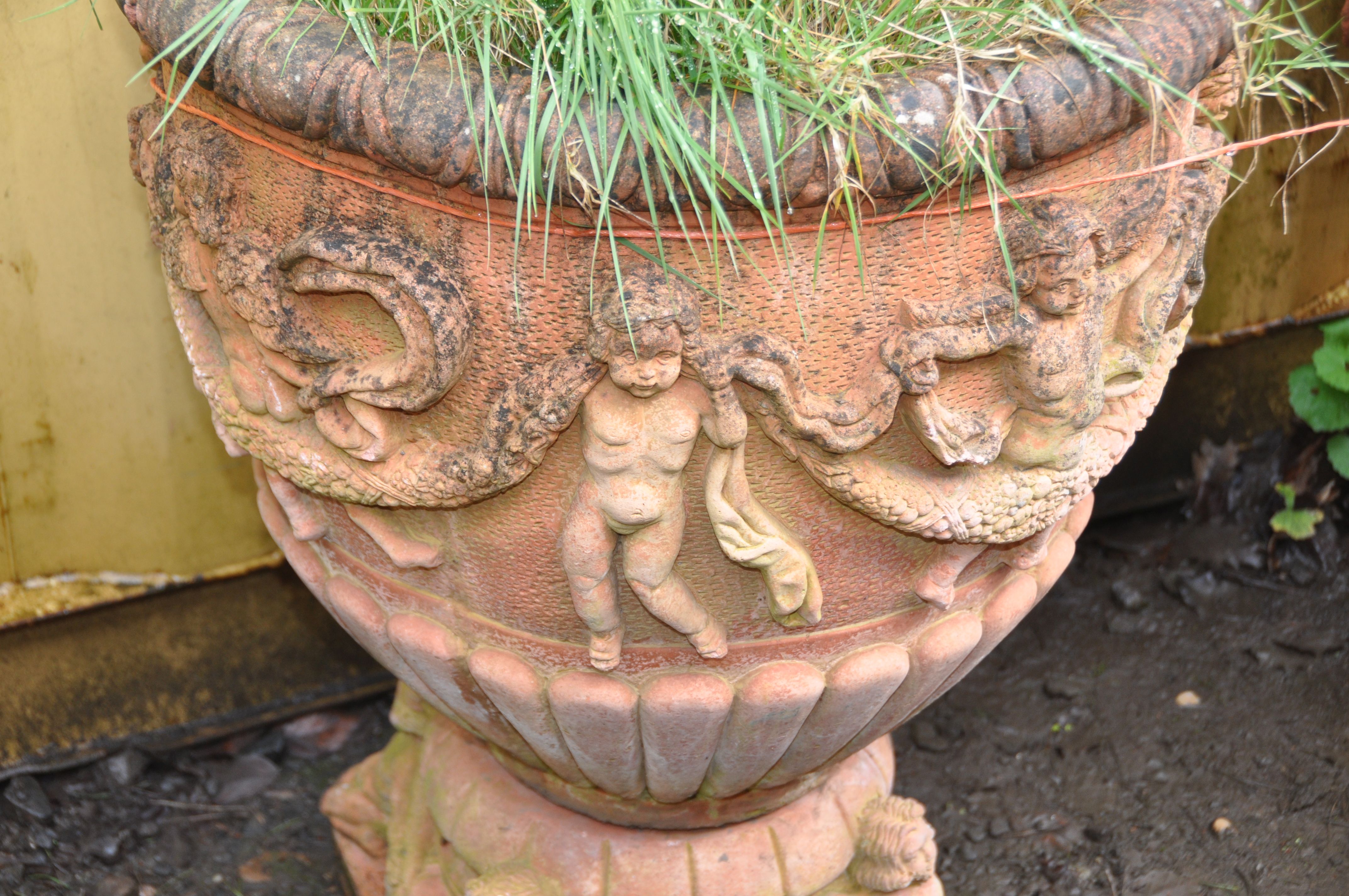 A PAIR OF LARGE MODERN COMPOSITE GARDEN URNS, terracotta painted, with Cherubs holding garlands of - Image 2 of 5