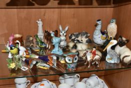 A COLLECTION OF ANIMAL AND BIRD FIGURES, over twenty pieces, to include a Beswick lying down Siamese
