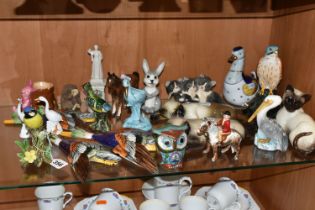 A COLLECTION OF ANIMAL AND BIRD FIGURES, over twenty pieces, to include a Beswick lying down Siamese
