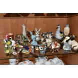 A COLLECTION OF ANIMAL AND BIRD FIGURES, over twenty pieces, to include a Beswick lying down Siamese