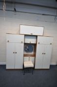 A MID CENTURY BEDROOM FITMENT, comprising two double door sections, each with a rise and fall