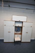 A MID CENTURY BEDROOM FITMENT, comprising two double door sections, each with a rise and fall