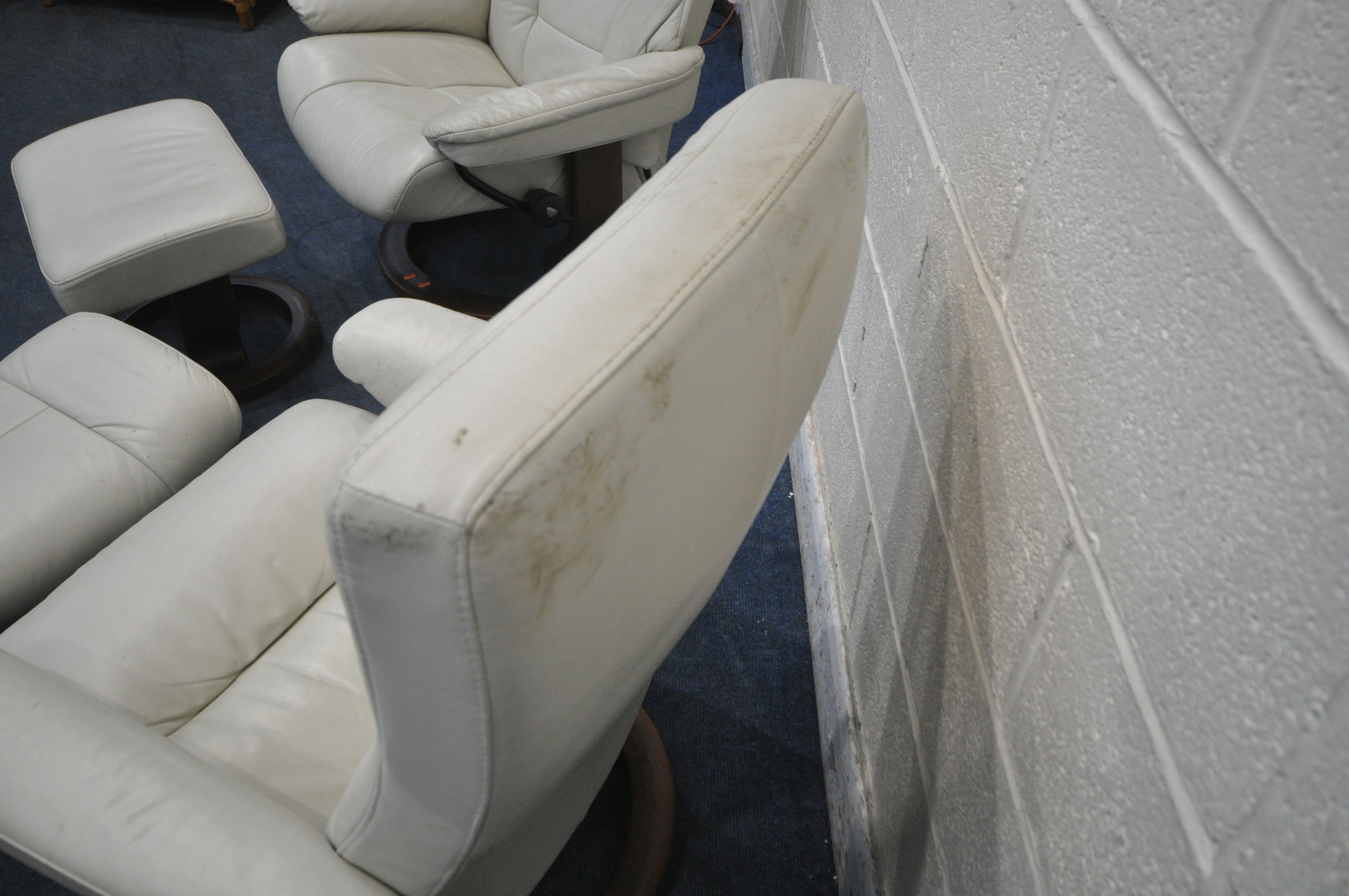 TWO SIZED EKORNES STRESSLESS CREAM LEATHER ARMCHAIRS, along with a pair of footstools (condition - Image 6 of 6