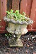 A WEATHERED COMPOSITE CAMPAGNA GARDEN URN with fluted bowl and square foot 56cm in diameter (